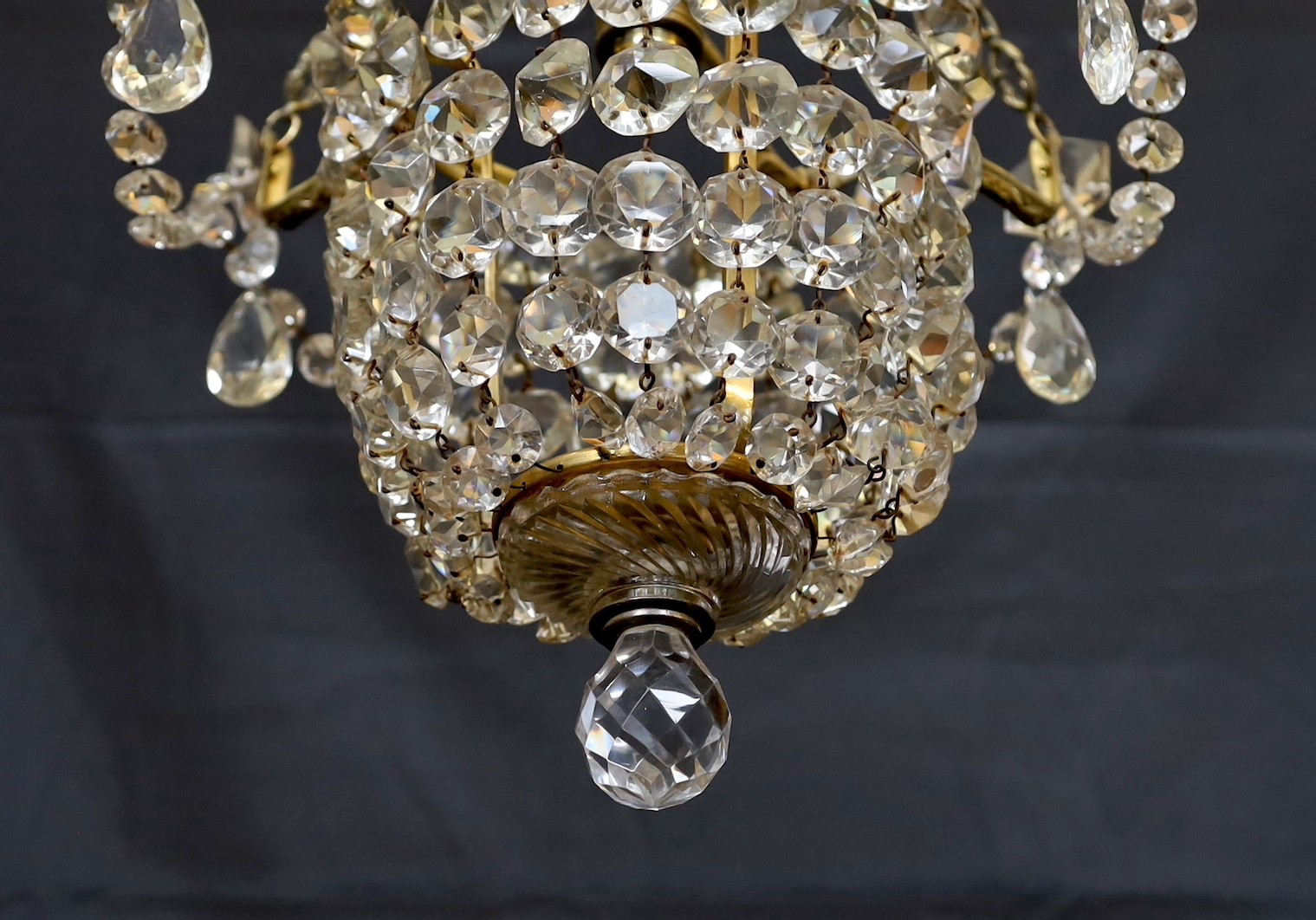 A 1930s lead crystal and brass bag shaped light fitting, height 53cm. width 36cm